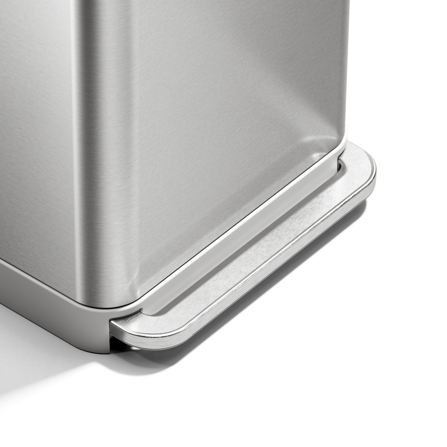 Close-up of Simplehuman 55L Rectangular Step Can brushed stainless steel pedal, hands-free design.