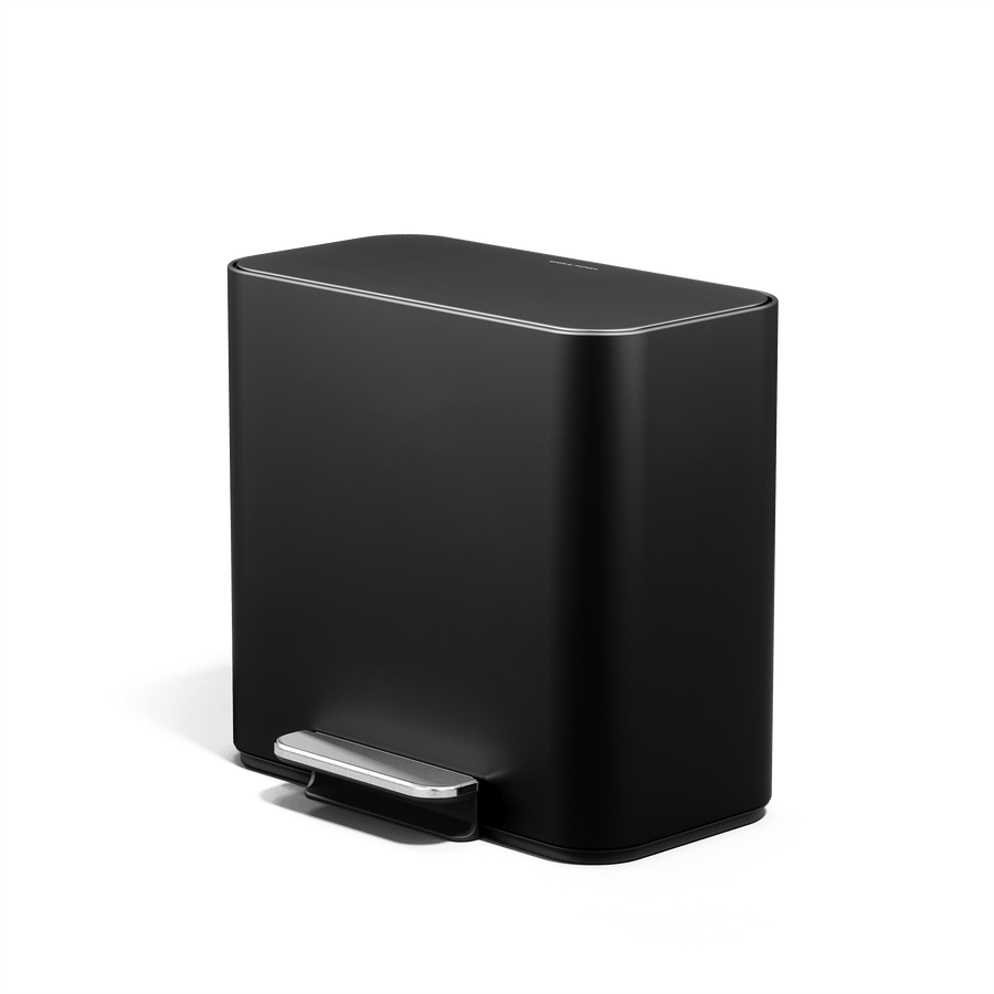 Lifestyle view of Simplehuman 15L Mini Recycler Step Can in Matte Black angled view.