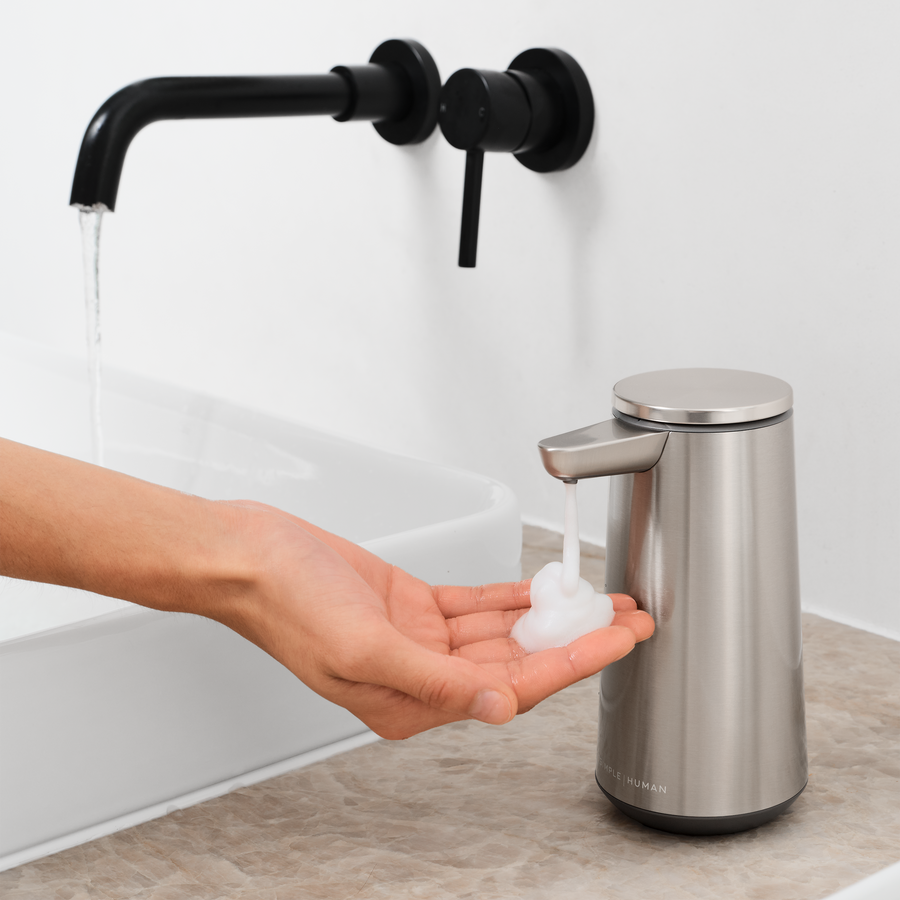 Simplehuman Brushed Stainless Steel Sensor Pump Foam dispensing rich foam soap into a hand, touch-free use.