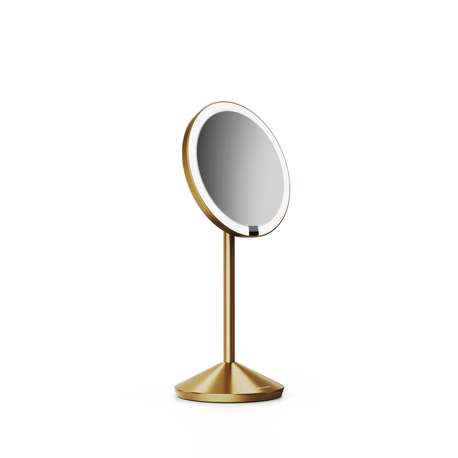 Simplehuman's Sensor Mirror Fold in Brass, angled view.