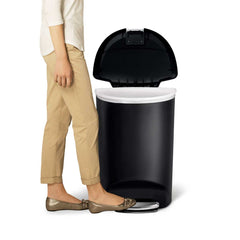 50L semi-round plastic step trash can - black - lifestyle foot on pedal image