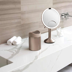 mini can - rose gold stainless steel w/ pink trim - lifestyle on counter with mirror and cotton balls image