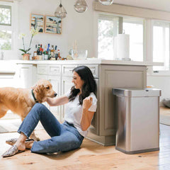 58L rectangular sensor can with voice and motion control - brushed stainless steel - lifestyle woman and dog image