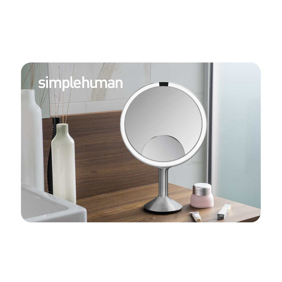 Lifestyle view of Simplehuman Sensor Mirror, Brushed Stainless Steel, with hands-free tru-lux lighting.