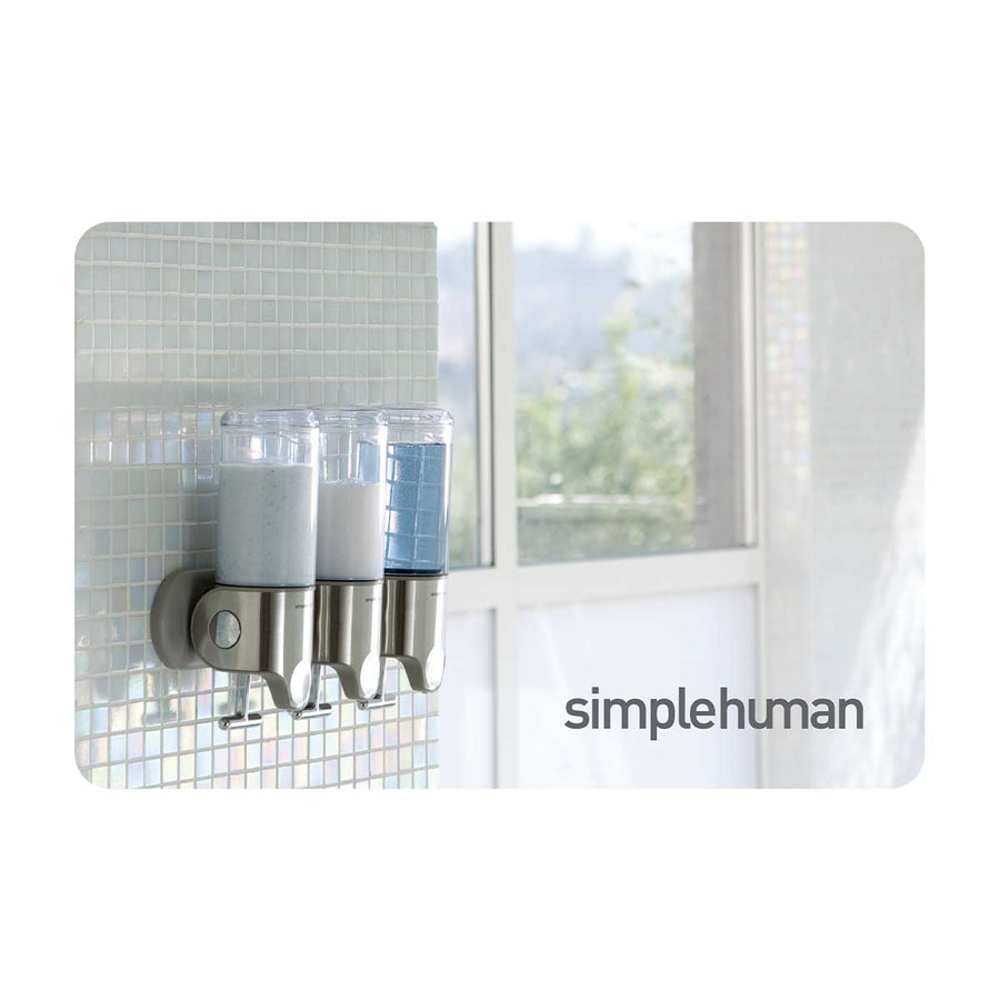 Simplehuman Triple Wall Mount Pump in Brushed Stainless Steel on a tiled shower wall, space-saving dispensing.